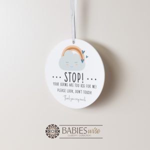 Round white acrylic plaque with hole for hanging on a pram or cot , UV printed with "STOP!" with message and a sleeping cloud and rainbow illusration. Styled hanging by a ribbon.