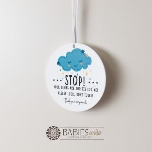 Round white acrylic plaque with hole for hanging on a pram or cot , UV printed with "STOP!" with message and a sleeping cloud and stars illusration. Styled hanging by a ribbon.
