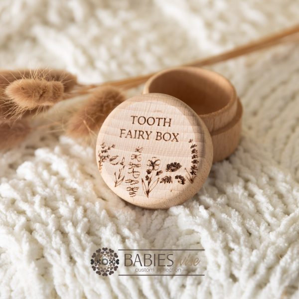 Timber tooth fairy box with engraved "Tooth Fairy Box" and small floral design along the bottom. Styled with a soft blanket and Bunny Tails Grass.