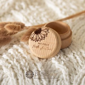 Timber keepsake box with engraved sunflower and "My first Tooth & Curl' text. Styled with a soft blanket and Bunny Tails Grass.