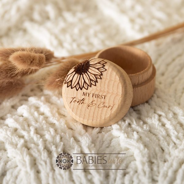 Timber keepsake box with engraved sunflower and "My first Tooth & Curl' text. Styled with a soft blanket and Bunny Tails Grass.