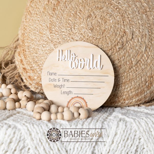 Hello World- Timber UV Printed brown Rainbow, 3D Acrylic Birth Announcement Plaquend rainbow design featuring spaces for baby's name, date, time, weight and lenght. Styled with a soft blanket and woven pillow.
