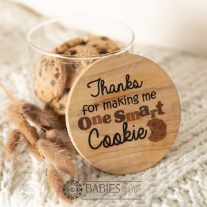 Glass gift jar with UV printed timber lid reading- "Thanks for making me one smart cookie". STyled with cookies on a soft blanket.