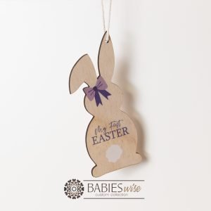 My First Easter bunny tag made from timber with purple bow, hanging hole and printed "My First Easter" text. Styled on hanging.