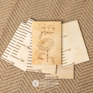 Timber growth chart with five panels and laser engraved header "Look at us grow" text with sunflower. Styled with woven mat.