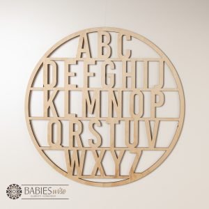 Timber alphabet wall art circle design with A-Z letters for nursery decor. Styled in a nursery theme.