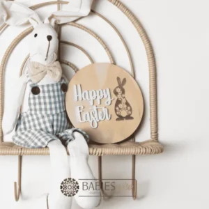 Happy Easter round timber plaque with laser engraved floral bunny and 3D acrylic "Happy Easter" lettering. Styled with a soft toy bunny on a wicker chair.