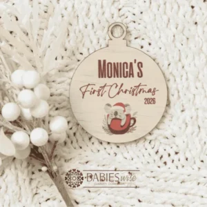 Round timber Christmas bauble UV printed with a selection of designs to choose from and personlised child's name and "First Christmas" with the year. Includes a hole to hang from the Christmas Tree. Style on a warm, soft blanket with a white Christmas wreath.