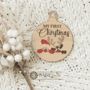 Round "My First Christmas" UV printed Bauble available in timber or UV printed acrylic in olive or Latte colours. Features festive Christmas illustrations and a hole for hanging on the Christmas tree. Styled hanging from a knob with decorative beads.