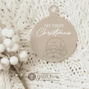 Round "My First Christmas" UV printed Bauble available in timber or UV printed acrylic in olive or Latte colours. Features festive Christmas illustrations and a hole for hanging on the Christmas tree. Styled hanging from a knob with decorative beads.