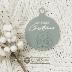 Round "My First Christmas" UV printed Bauble available in timber or UV printed acrylic in olive or Latte colours. Features festive Christmas illustrations and a hole for hanging on the Christmas tree. Styled hanging from a knob with decorative beads.