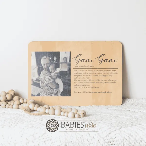 Personlised timber photo plaque featuring a cherished grandmother-and-grandchild customer supplied photograph along with a heartfelt definition of the word "Mother. Styled on a soft white blanket with wooden decorative beads.