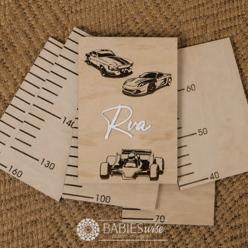 Personlised Timber Growth Charts laser engraved Header with race cars and 3D acrylic child's name in script lettering. Styled as a flat-lay photo on a woven mat with the panels.