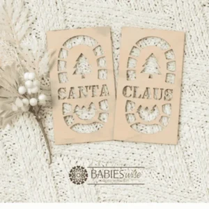 Set of two timber Santa footprint stencils designed to create Christmas Eve boot prints. One stencil features "HO HO Santa Claus" and the other a small "Christmas tree Santa Claus". Styled on a soft white blanket with a white Christmas wreath.