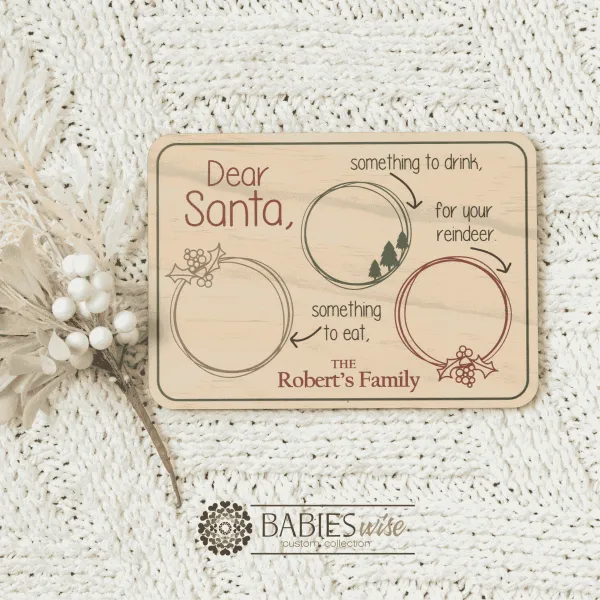 Retangle Timber Santa Snack tray available in UV printed colour or laser engraved finish. Features sections for Santa's drink, snack and reindeer treats with personlised family or children's names along the bottom of the tray. Styled on a soft white blanket with a white Christmas wreath.