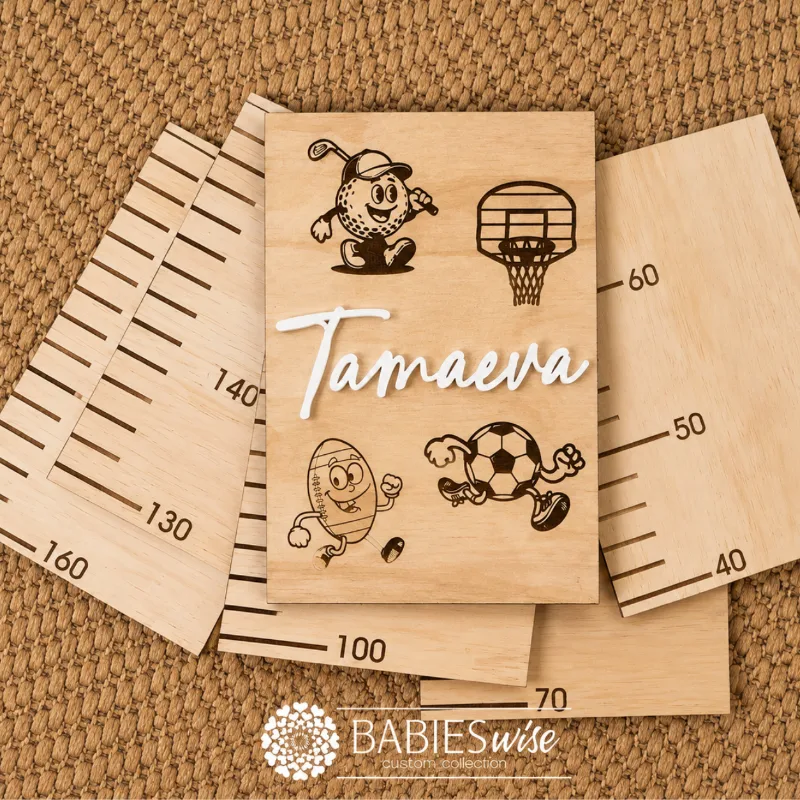 Personlised Timber Growth Charts laser engraved Header with sports illustrations and 3D acrylic child's name in script lettering. Styled as a flat-lay photo on a woven mat with the panels.