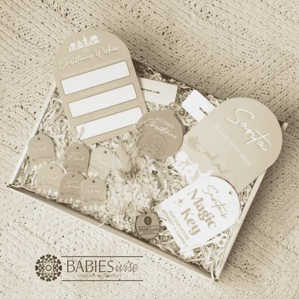 Christmas Gift Box Acrylic UV printed Latte featuring a corordinated colllection of reusable Christmas keepsakes in soft latte and white tones, beautifully presented in a whit gift box. Styled on a soft white blanket.