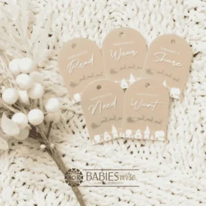 Set of Christmas gift tags featuring the words Wear, Read, Want, Share and Need. Available in timber olive acrylic or latte acrylic with festive Christmas illustration. Styled on a soft white blanke with a white wreath.