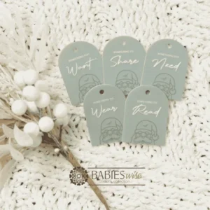 Set of Christmas gift tags featuring the words Wear, Read, Want, Share and Need. Available in timber olive acrylic or latte acrylic with festive Christmas illustration. Styled on a soft white blanke with a white wreath.