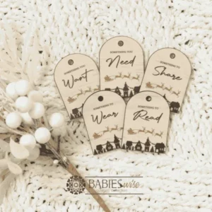 Set of Christmas gift tags featuring the words Wear, Read, Want, Share and Need. Available in timber olive acrylic or latte acrylic with festive Christmas illustration. Styled on a soft white blanke with a white wreath.