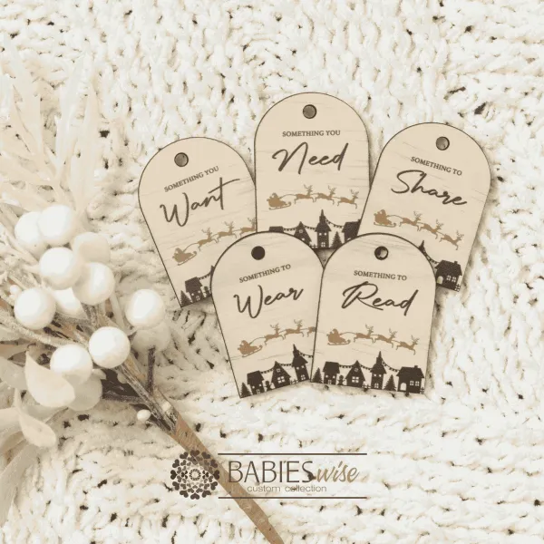 Set of Christmas gift tags featuring the words Wear, Read, Want, Share and Need. Available in timber olive acrylic or latte acrylic with festive Christmas illustration. Styled on a soft white blanke with a white wreath.